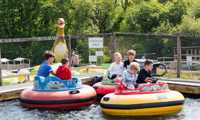 Three groups of boys on the disco boats having fun on the water
